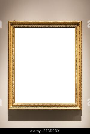 Vertikaler schmaler Bilderrahmen aus Vintage-Holz mit ausgeschnittener Leinwand, die an der Wand hängt und von elektrischem Licht beleuchtet wird Stockfoto