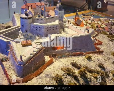 Detailliertes Modell oder Diorama, das eine mittelalterliche europäische Festungsanlage mit umgebender Siedlung darstellt. Die Miniatur besteht aus Stein Stockfoto