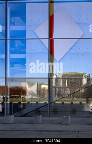 Ein eindrucksvolles architektonisches Foto, das die Reflexion moderner Gebäude und Landschaftsgestaltung in einer Glasfassade zeigt. Das Bild erfasst eine dynamische Inte Stockfoto