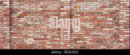 Panorama-Ziegelwand aus verschiedenfarbigen Ziegeln mit hervorstehenden Wandsäulen Stockfoto