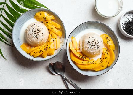 Mango Sticky Reis mit Kokosmilch auf weißem Hintergrund, Draufsicht. Traditionelle thailändische Mahlzeit. Khao niao mamuang. Stockfoto