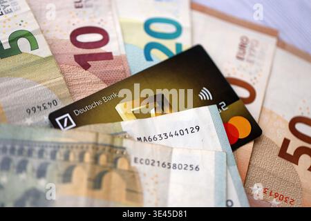 KIEW, UKRAINE - 28. JANUAR 2026 Deutsche Bank Karte und deutsche Euro-Geldscheine auf dem Tisch Nahaufnahme. Die Deutsche Bank ist die beliebteste Bank in Deutschland Stockfoto