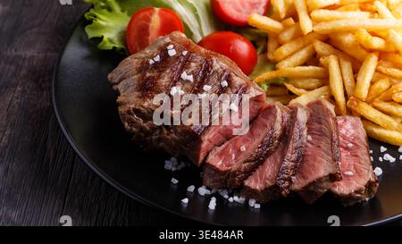 New York Steak mit Pommes frites und Salat. Stockfoto