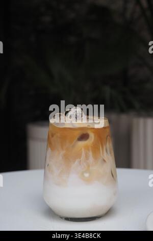 Eiskaffee mit Milch serviert in einem Glas auf einem Tisch Stockfoto