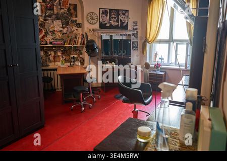 Innenansicht eines Friseursalons oder Schönheitssalons im Vintage-Stil mit professioneller Friseurausrüstung. Der Raum hat hellrote Böden und Stockfoto