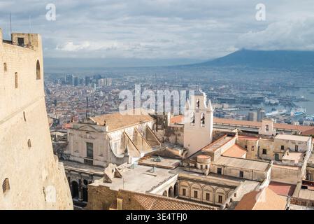 Neapel Italien, 18. November 2025 Panoramablick auf den Hafen von Neapel, die Stadtküste und die Silhouette des Vesuv unter einem bewölkten s Stockfoto
