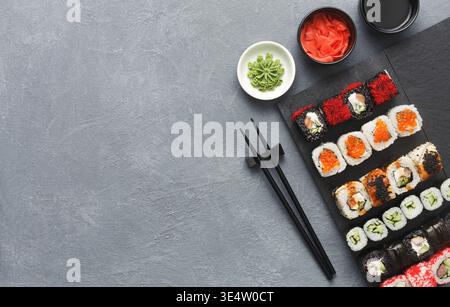 Set aus Sushi Maki und Rollen auf grauem Hintergrund Stockfoto