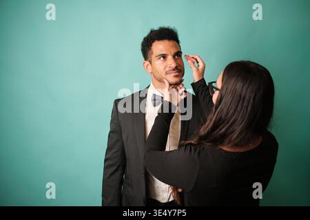 Make-up-Künstler, der den Schauspieler vor der Veranstaltung schminkt Stockfoto