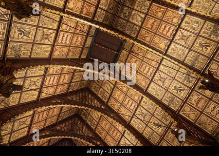 Reich bemalte heraldische Decke der Rochdale Town Hall Great Hall mit vergoldeten Tafeln mit Wappen, Laub und mythischen Kreaturen. Stockfoto