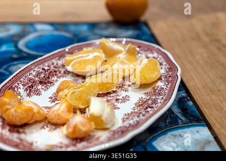 Ein Haufen geschälter Mandarinen auf einer Keramikschale, in der Nähe Stockfoto