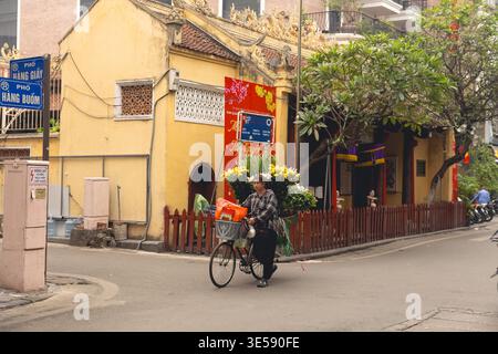 Fahrradstraßenverkäufer, der Blumen in der Hang Buom Street in Hanoi Old Quarter, Hanoi, Vietnam, am frühen Morgen verkauft Stockfoto
