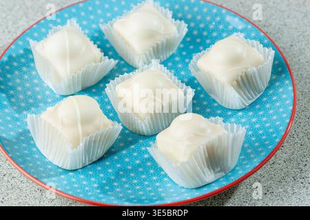 Sechs Mr. Kipling Frosty auf einem blauen Teller. Stockfoto