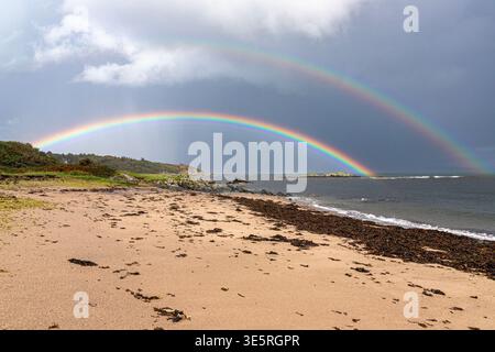 Ein doppelter Regenbogen über dem Meer an der Ostküste der Kintyre Peninsula in der Nähe von Peninver, Argyll & Bute, Schottland Großbritannien Stockfoto