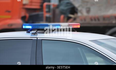 Polizeipatrouillenfahrzeug mit blinkenden blauen und roten Notlichtern auf der Stadtstraße Stockfoto