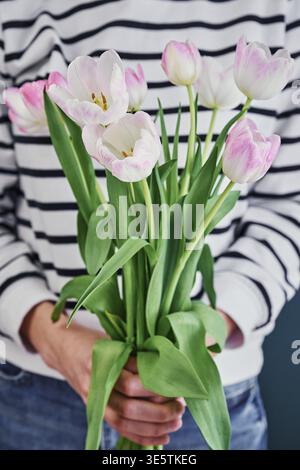 Frau hält Tulpenblüten Blumenstrauß in den Händen Stockfoto