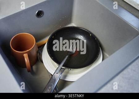 Ein Haufen ungewaschenes, schmutziges Geschirr im Spülbecken Stockfoto