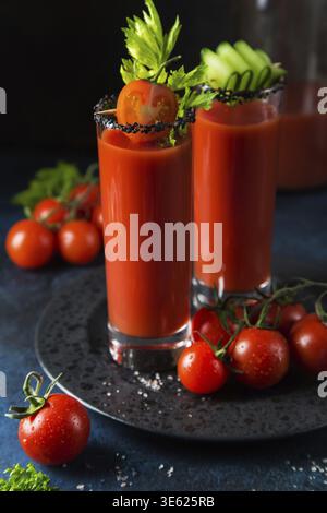Essen, Gläser Tomatensaft serviert mit Gurke und Sellerie Stockfoto