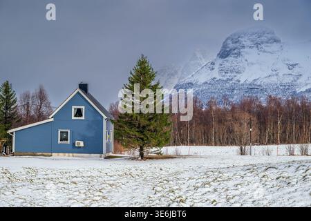 Ländliches Holzhaus mit Lyngen Alps im Hintergrund, Overgard, Troms, Norwegen Stockfoto