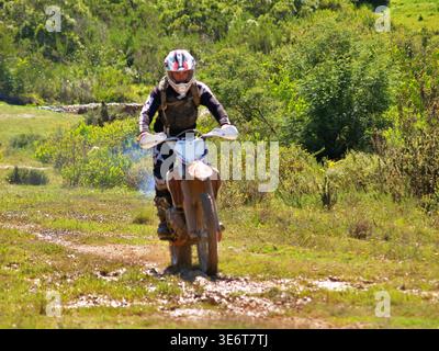 Geländegängige Enduro-Motorradfahrer fahren mit einem KTM-Dirt-Bike durch Waldwege und schlammiges Gelände in Jeffreys Bay. Südafrika Stockfoto