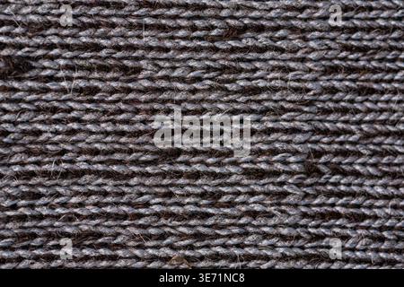 Dunkle Alpakawolle gestrickt Textil Makrostruktur Naturfaser Hintergrund Stockfoto