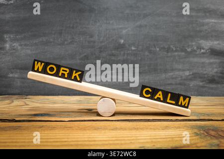 Eine Holzsäge zeigt ARBEIT und RUHIGE Worte, die das Gleichgewicht zwischen Anstrengung und Ruhe darstellen Stockfoto