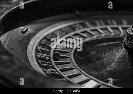 Nahaufnahme einer gebrauchten Vintage-Schreibmaschine mit Fokus auf Roller und Platte in einem schwach beleuchteten Casino-Innenraum Stockfoto