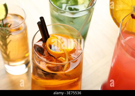 Verschiedene leckere erfrischende Cocktails in Gläsern auf dem Tisch, Nahaufnahme Stockfoto