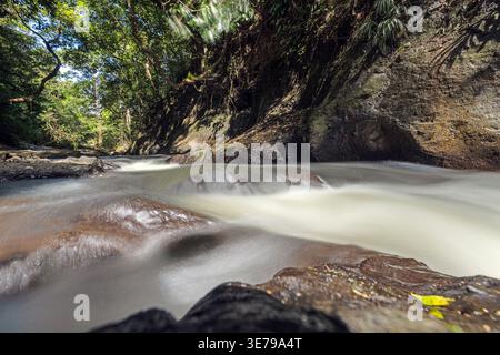 Malerischer tropischer Fluss mit glattem Wasser und Felsformationen im dichten Regenwald Valle de Anton Panama bereisen die Natur im Hintergrund Stockfoto
