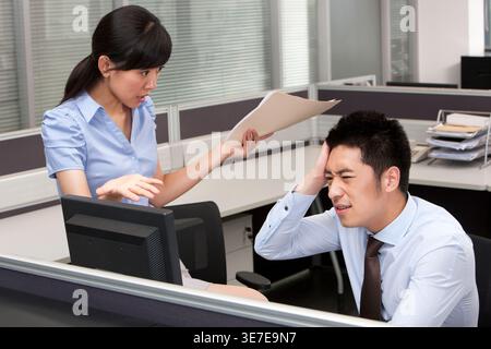 Betonte chinesische Büroangestellte, die Probleme bei der Arbeit im Büro hatten Stockfoto