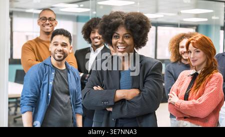 Schwarze Frau mit Afro, die vor Kollegen im Büro gekreuzt ist Stockfoto