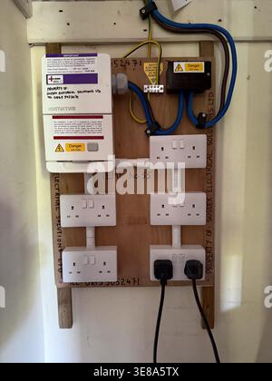 Eine detaillierte Nahaufnahme einer elektrischen Leiterplatte mit integrierten Komponenten und Steckdosen, die moderne Elektronik und Konnektivität veranschaulicht. Stockfoto