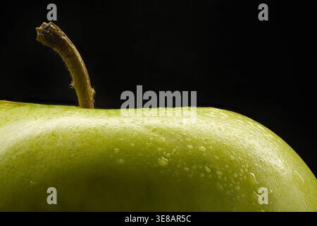 Premium frischer grüner Apfel mit Wassertropfen Makronaht auf schwarzem Hintergrund, gesundes Luxuskonzept Stockfoto