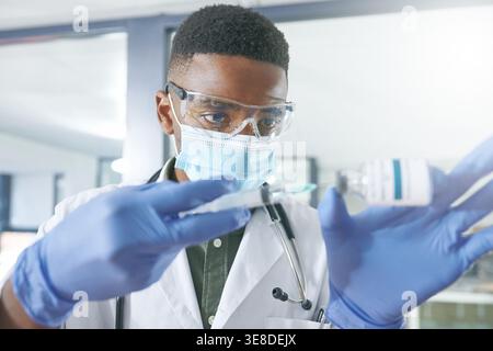 Arzt, Impfstoff und Gesichtsmaske mit Mann und Fläschchen für klinische Studie, Apotheke Behandlung und medizinische. Krankheitsprotokoll, Gesundheitssicherheit und Medikamente mit Stockfoto