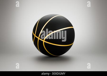 Schwarzer Basketball mit goldenen Linien auf grauem Studiohintergrund Stockfoto