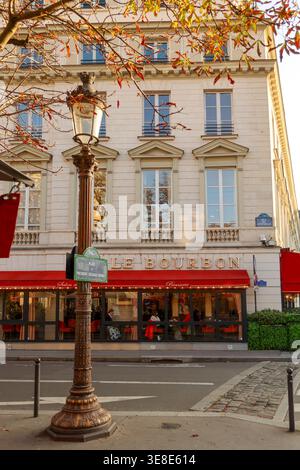 Paris, Frankreich. Oktober 2025. Die Brasserie Le Bourbon ist im Herbst an einer Pariser Straße mit Menschen im Haus Stockfoto