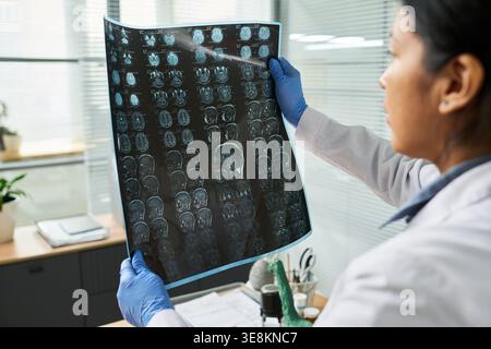 Ärztin untersucht Gehirn-MRT in der Klinik, beurteilt neurologische Diagnostik und Behandlungsplanung. Ideal für Gesundheitsmarketing, Radiologie, Neurologie, medizinische Dienstleistungen Stockfoto