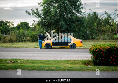 Der Fahrer überprüft den Motor eines Pannenwagens Stockfoto