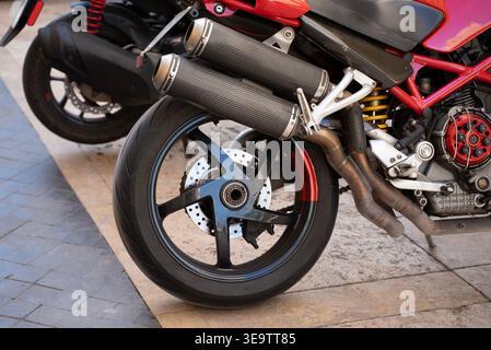 Hinterrad und Auspuff des Motorrads in Nahaufnahme mit Details zum Sportmotorrad Stockfoto