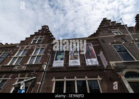 Flacher Blick auf die historische Ziegelfassade mit Ausstellungsbändern, die an Ziersteinmauerwerk hängen, Frans Hals Museum, Haarlem, Niederlande. Stockfoto