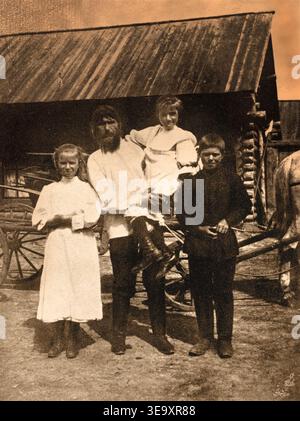 Grigori Yefimowitsch Rasputin (1869–1916) war ein russischer Mystiker und Vertrauter der Familie des Zaren Nikolaus II.. Dieses Foto, das vor 1910 aufgenommen wurde, zeigt Rasputin mit seinen Kindern Dmitri, Varvara und Matryona (oder Maria), die einzigen Überlebenden der sieben, die er zeugte. Stockfoto