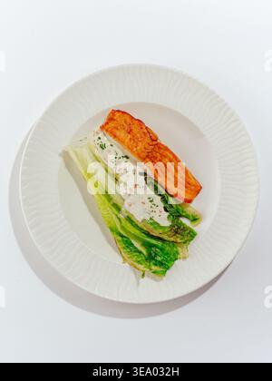 Gegrillter Lachs mit Sauce und Gemüse auf einem Teller Stockfoto