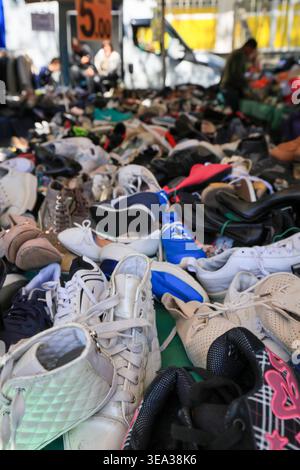 Verschiedene Turnschuhe und Schuhe werden an einem Straßenmarkt ausgestellt. Rom, Italien - 19. April 2026: Eine Nahaufnahme eines Schuhstandes auf dem Flohmarkt Porta Portese. Mehrere Paar Sneakers und Freizeitschuhe sind ordentlich auf Metallregalen und weißen Tischen angeordnet. Ein großes gelbes Preisschild ist an der Metallstruktur des Stalls unter dem hellen Morgenlicht angebracht. Rom RM Italien Copyright: XGennaroxLeonardix Stockfoto