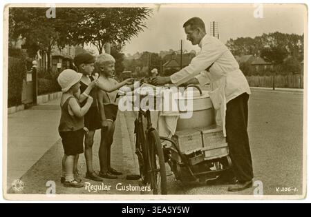 1900er, 1920er Jahre Straßenverkäufer Mann verkauft Eis, eis, eis, eis, Eislollies an Kinder heißer Sommertag Sommer Kinder kaufen Eisverkäufer mit Fahrrad, UK Stockfoto