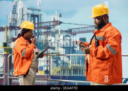 Offshore-Plattform-Engineering-Team Brainstorming, Verwaltung von Wartungssystemen, Planung von Infrastrukturreparaturen. Kollegen überwachen die mechanische und strukturelle Integrität des Bohrgeräts mit Geräten Stockfoto