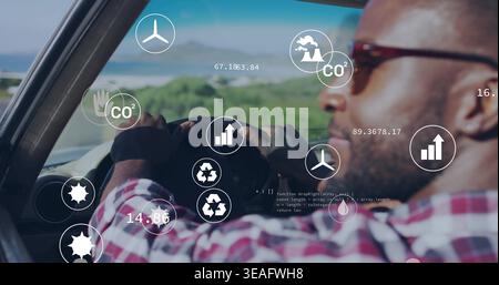 Fahrender Mann mit Sonnenbrille und kariertem Hemd im Auto, Lenkrad gehalten und HUD-Überzüge gezeigt Stockfoto