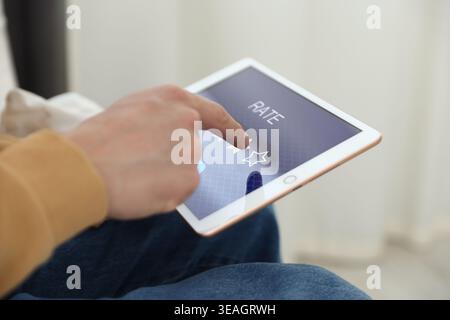 Mann mit Sternen auf Tablet drinnen, Nahaufnahme Stockfoto