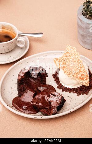 Dekadente Dessertpräsentation. Samtiger Geschmolzener Schokoladenkuchen Mit Knusprigen Keksen Und Kaltem Eis Stockfoto