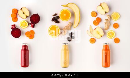 Set von Detox Smoothies in Glasflaschen, Früchten, Nüssen und Gewürzen Stockfoto
