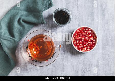 Entgiften Sie grünen Granatapfeltee in einer Tasse auf dem Tisch Stockfoto