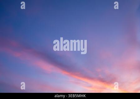 Abstrakter farbenfroher Himmelhintergrund mit weichen rosa und lila Wolken beleuchtet durch Sonnenuntergangslicht. Ideal für Design, Tapeten, Präsentationen, Social Media Stockfoto